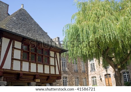 Dinan (Cotes-d\'Armor, Brittany, France) - Exterior of ancient half-timbered house and willow
