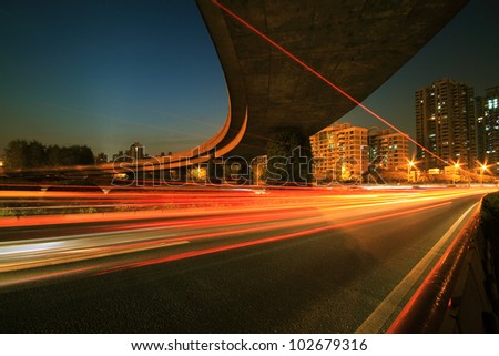 Urban focus of a major cities ring highway viaduct with light trails night Scene