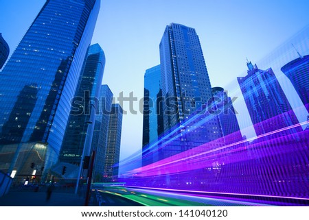 The urban background of modern office buildings car night light trails in Shanghai