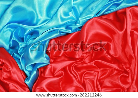 Blue and red Silk cloth of abstract background or wavy folds or satiny silk texture satin velvet material or elegant wallpaper design curve.