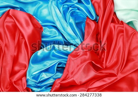 Blue and red and light green silk texture satin velvet material or elegant wallpaper design curve backgrounds
