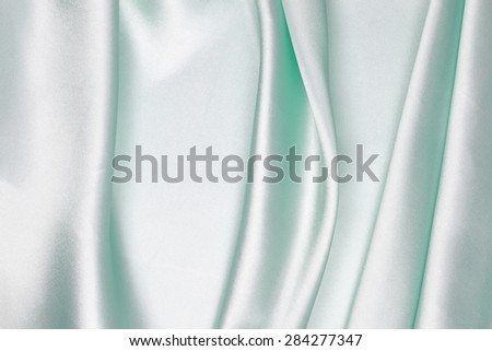 Light green silk texture satin velvet material or elegant wallpaper design curve