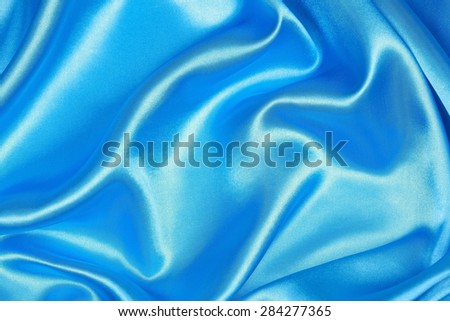 Blue silk texture satin velvet material or elegant wallpaper design curve