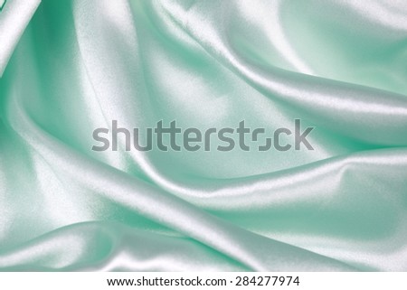 Light green silk texture satin velvet material or elegant wallpaper design curve
