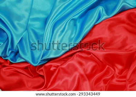 Blue and red Silk cloth of abstract backgrounds or wavy folds or satiny silk texture satin velvet material or elegant wallpaper design curve.