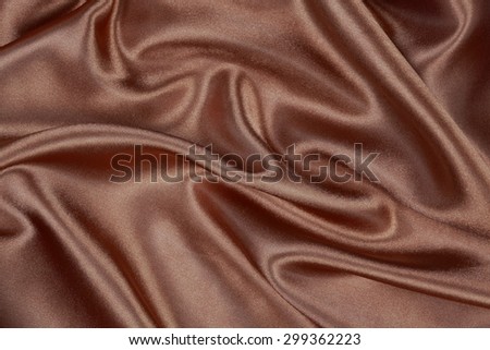 Brown silk texture satin velvet material or elegant wallpaper design curve folds wavy background
