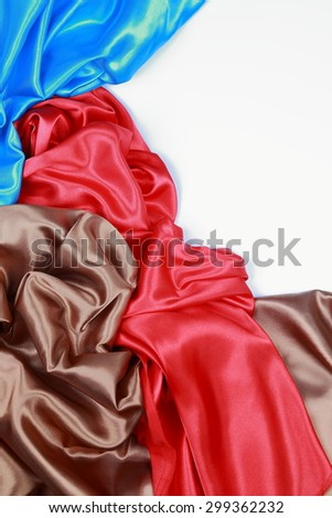 Blue and brown and red silk texture satin velvet material or elegant wallpaper design curve folds wavy background isolated on white background