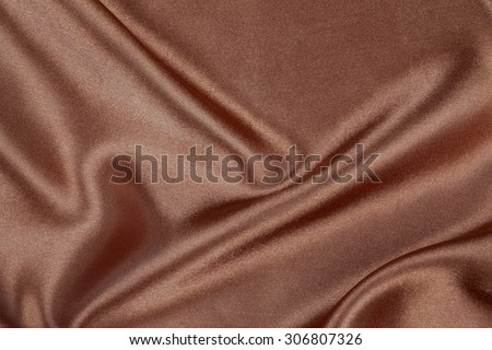 Brown silk texture satin velvet material or elegant wallpaper design curve folds wavy background