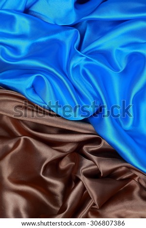 Blue and brown silk texture satin velvet material or elegant wallpaper design curve folds wavy background