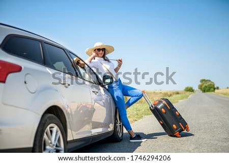 Pretty girl with suitcase standing near car and wiat for her dreaming trip Zdjęcia stock © 