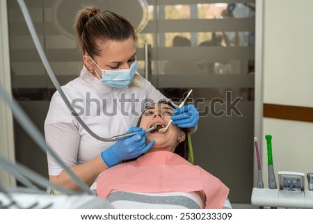 Similar – Image, Stock Photo Dentist treating teeth of patient with UV light