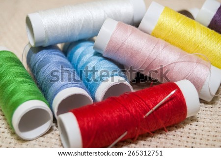set of multi-colored rainbow threads for sewing with needle