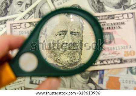 50 US dollars under a magnifying glass. close-up