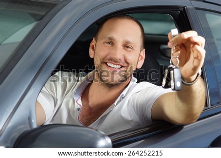 Happy new car owner keep car keys in his hands