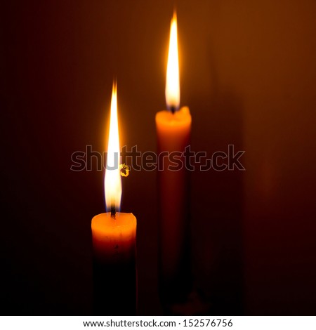 burning two candles in dark