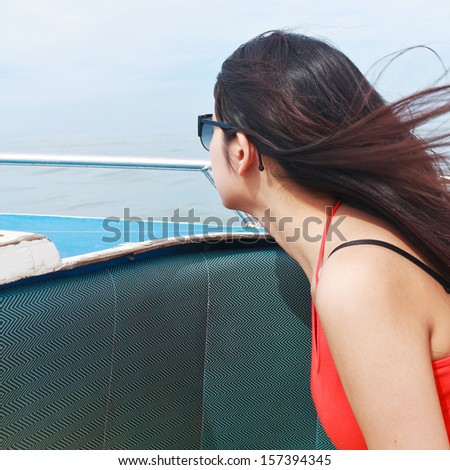 A beautiful young woman relaxing on speed boat, Krabi Thailand