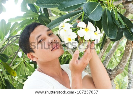 Lost in Paradise,Man holding on Frangipani Flower