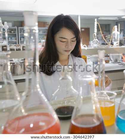 Young Asian chemical engineer work in a chemical lab