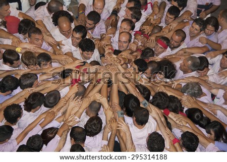 REUS, SPAIN - OCTOBER 3, 2009: Castells Performance, a castell is a human tower built traditionally in festivals within Catalonia. This is alsoon the UNESCO Intangible Cultural Heritage of Humanity