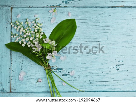 Lovely bouquet of lilies of the valley on a blue wooden table