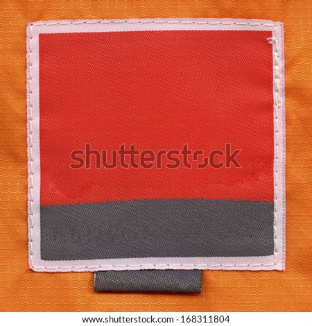 red-black textile label on yellow fabric background