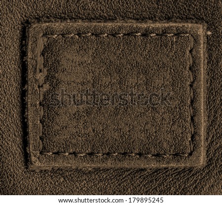 blank brown leather label on leather background
