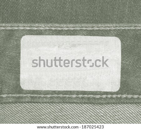 blank fabric label on green jeans background, Useful for Your text
