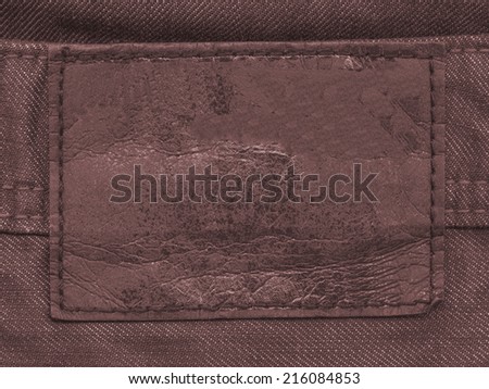 worn old brown  label on brown fabric background