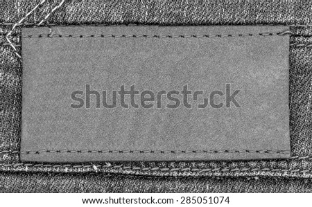 gray blank leather label on gray jeans background