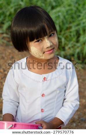 Sangklaburi,Thailand-May 3: Unidentified young asian girl with thanaka powder on face of this \