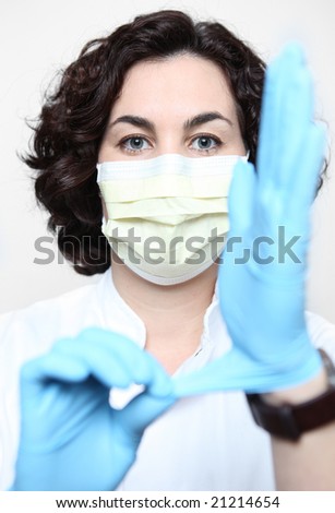 Nurse Adjusting Her Glove. Stock Photo 21214654 : Shutterstock