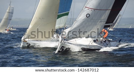 group yacht sailing together at race