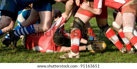 rugby scrum with a man lying down