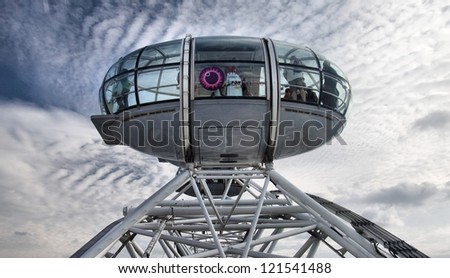 LONDON - JANUARY 26, 2012: A Participants of attraction London Eye in a cabin of a wheel of a review on January 26, 2012 in London, United Kingdom of Great Britain