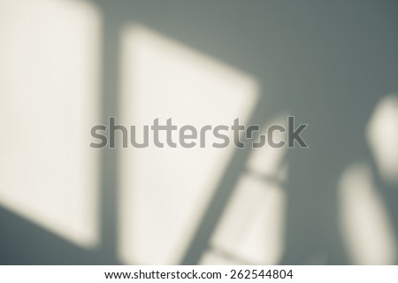 Abstract background of a white wall with shadows from the window.