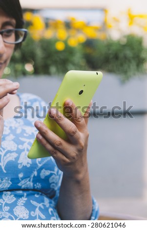 South Asian woman using a smartphone.