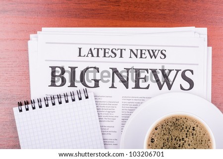 The newspaper LATEST NEWS with the headline BIG NEWS  and coffee