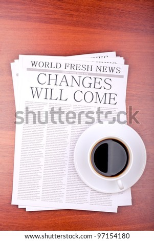 Newspaper CHANGES WILL COME and cup of coffee top view