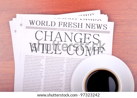 Newspaper CHANGES WILL COME and cup of coffee top view