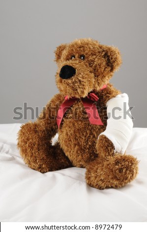 a teddy bear with a fractured arm at the hospital