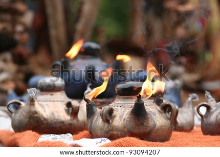 Arabic Oil Lamp with flames coming out of the pipes.