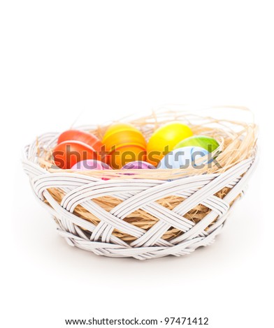 Colorful Easter eggs. Hand painted colorful Easter eggs arranged with natural hay and isolated on white background.