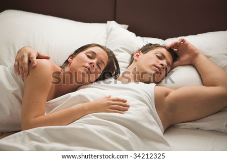 Young attractive couple sleeping in the mornig