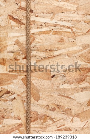 Rope lying on oriented strand board, with space for your text