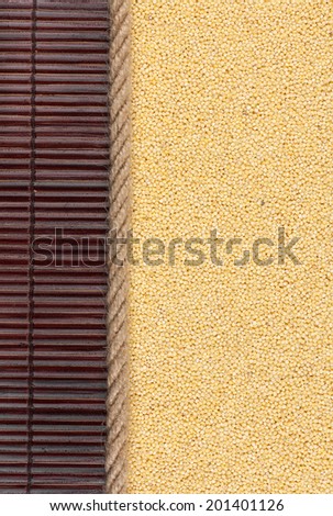 Millet lying on dark bamboo mat, for menu, can be used as background