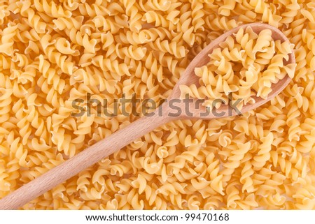 wooden  spoon yellow macaroni, vermicelli  food background