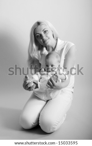 Young happy smiling mother holds her baby