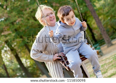 Grandmother and grandson playing in the park