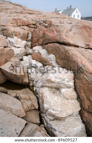 A Quartz-intrusion in fractured (red granite) rocks situated at the rugged coast of South-Norway.