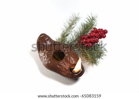 Ancient oil lamp with Christmas foliage